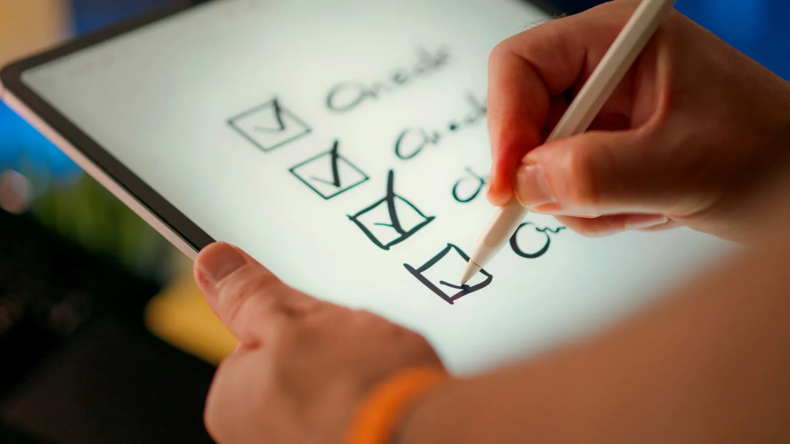 A checklist being marked with a stylus on a tablet