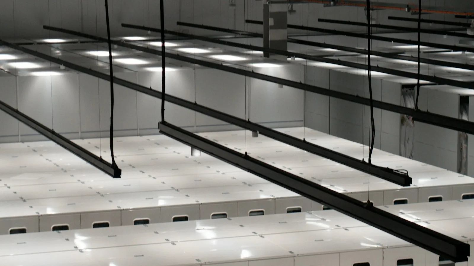 A modern data center filled with white server cabinets