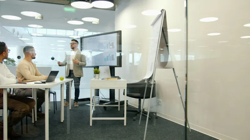 A manager giving a presentation to colleagues in an office meeting